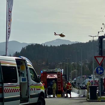 A helicopter flies above a road.