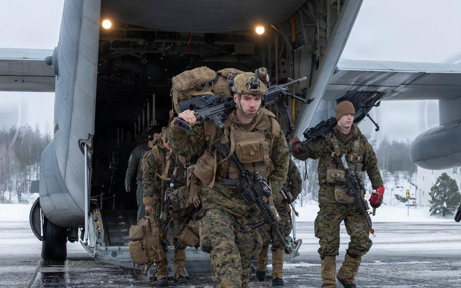 Marines depart a KC-130J Super Hercules aircraft.