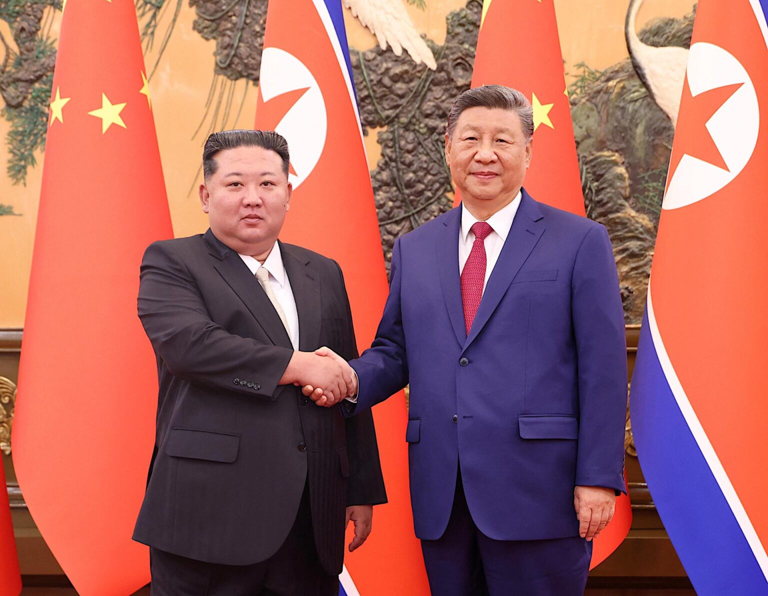 North Korean leader Kim Jong-un, left, and Chinese President Xi Jinping shake hands at the Great Hall of the People in Beijing, China Sept. 4. Reuters-Yonhap