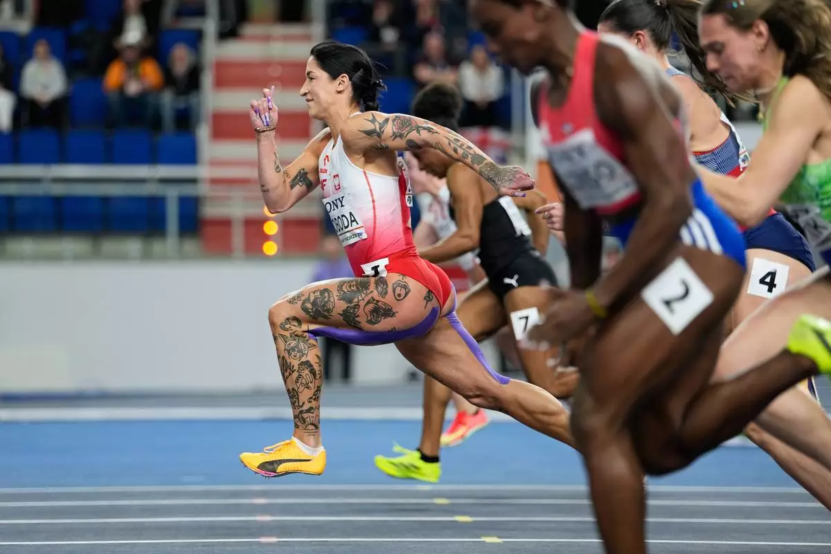 Ewa Swoboda, of Poland, leads in a woman's 60 meters heat at the World Athletics Indoor Championships in Torun, Poland, Saturday, March 21, 2026. (AP Photo/Matthias Schrader)