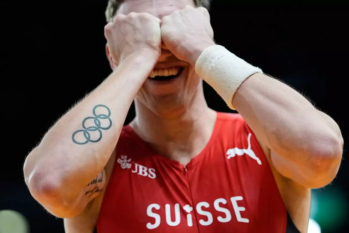 Simon Ehammer, of Switzerland, reacts after a successful attempt in the heptathlon pole vault at the World Athletics Indoor Championships in Torun, Poland, Saturday, March 21, 2026. (AP Photo/Matthias Schrader)