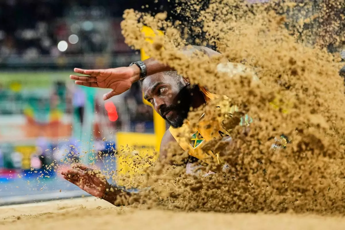 Jordan Scott, of Jamaica, competes during the men's triple jump final at the World Athletics Indoor Championships in Torun, Poland, Friday, March 20, 2026. (AP Photo/Matthias Schrader)