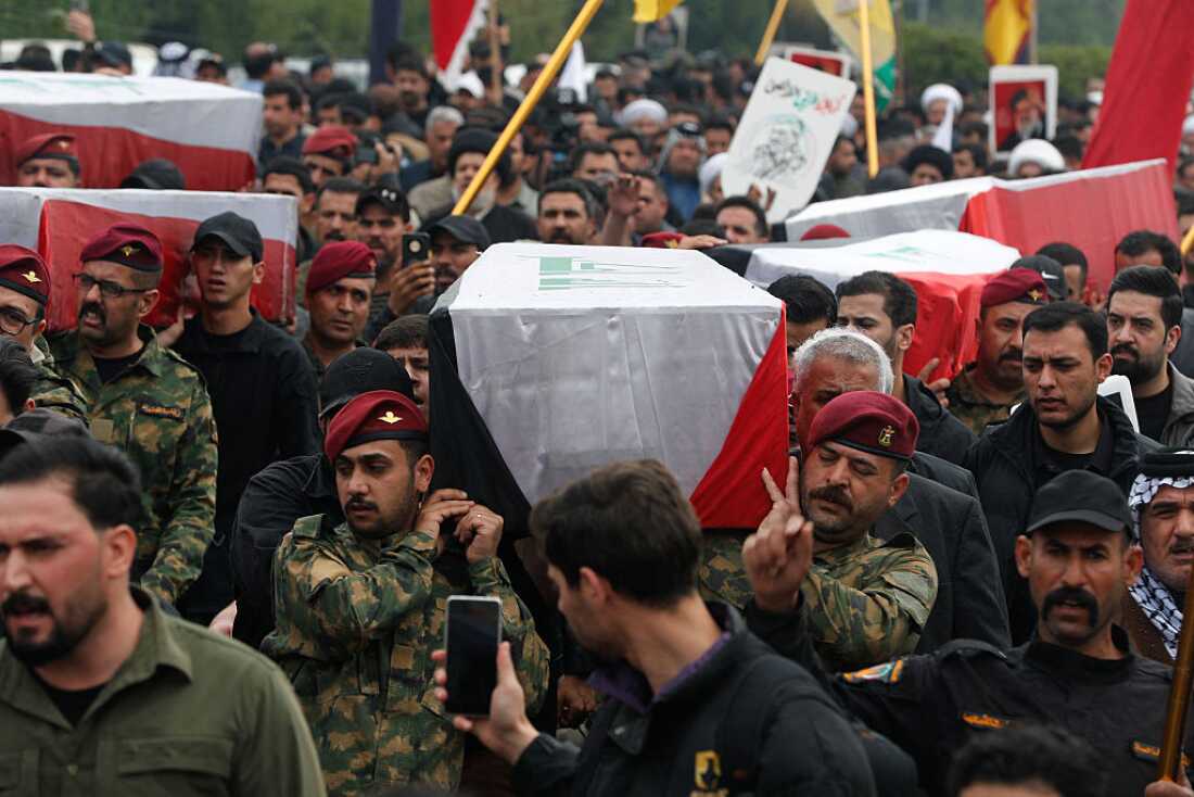 Members of Iraq's Hashed al-Shaabi, an alliance of factions now integrated into the regular army, carry the coffin of the Hashd al-Shaabi operations commander for Al-Anbar, Saad Dawai alongside others during a mass funaral in Baghdad on March 24, 2026.