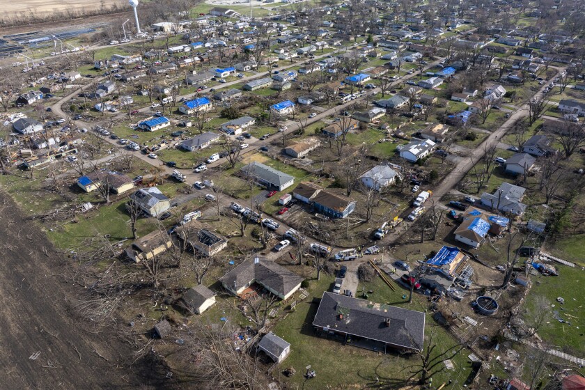 A high shot of a neighborhood where multiple homes have been damaged by tornadoes.