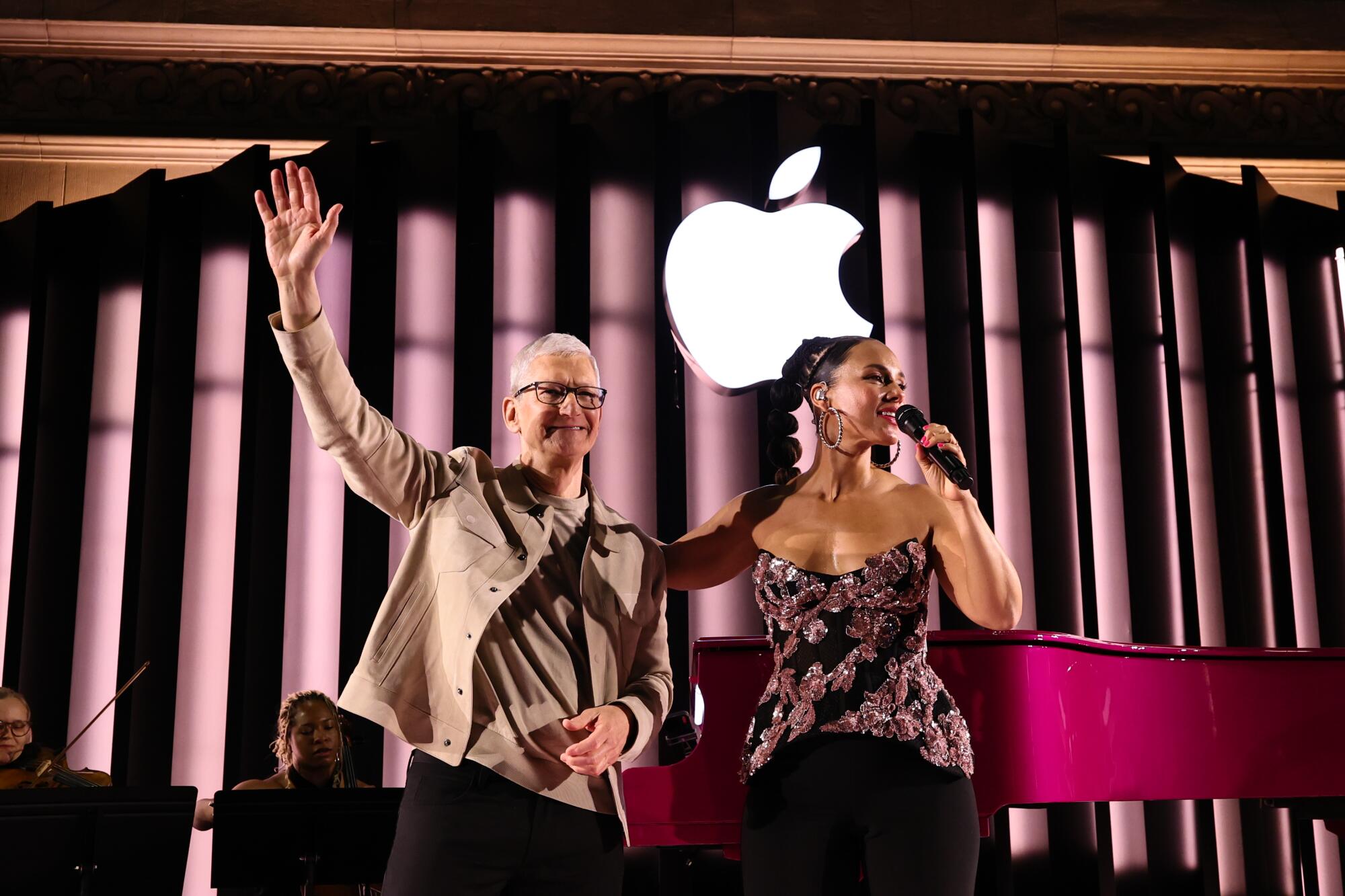 Tim Cook and Alicia Keys on a stage beneath the Apple logo