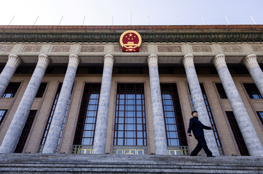 A man walks down the stairs at the entrance of the Great Hall of the People ahead of the annual National People's Congress...
