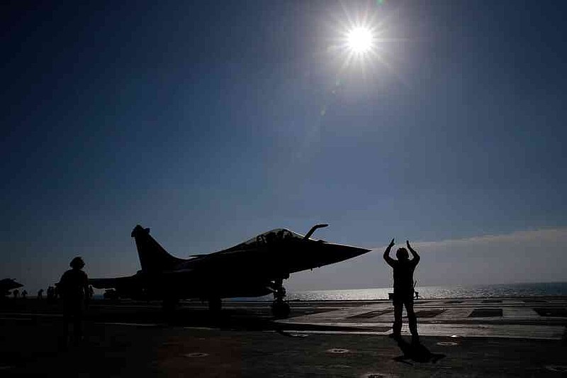FILE - A Rafale M single seater fighter jet is catapulted on France's flagship Charles de Gaulle aircraft carrier in the Persian Gulf, Jan. 12, 2016. (AP Photo/Christophe Ena, File)