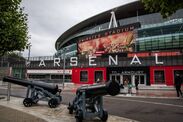 Ground view of the main entrance to Emirates Stadium in London, featuring the iconic cannons of Arsenal Football Club