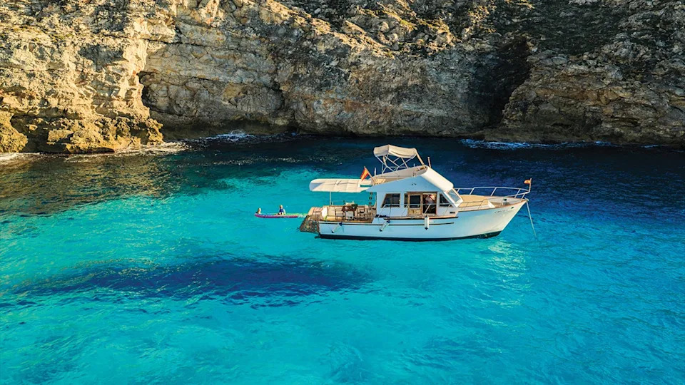 Son Vell’s 35-foot boat, L’Amo, in of Menorca’s beautiful coves.