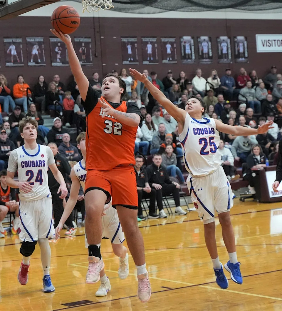 Summerfield's Easton Lapoint (32) squeezes by Dante Mathews (25) for two Friday night. Lenawee Christian's Jaxon Salenbien (24) looks on