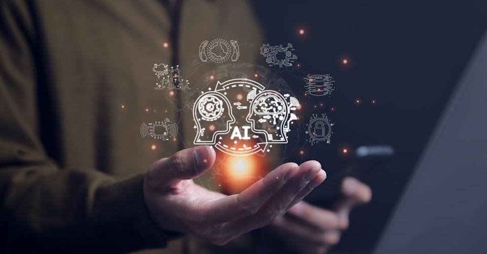 A person holding out an open palm with a graphic of a human interacting with an AI machine above it.