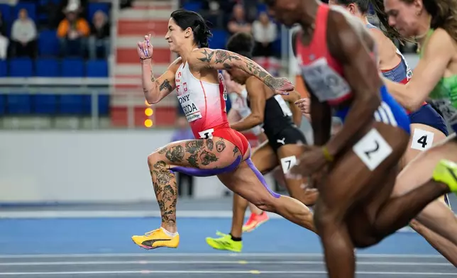 Ewa Swoboda, of Poland, leads in a woman's 60 meters heat at the World Athletics Indoor Championships in Torun, Poland, Saturday, March 21, 2026. (AP Photo/Matthias Schrader)