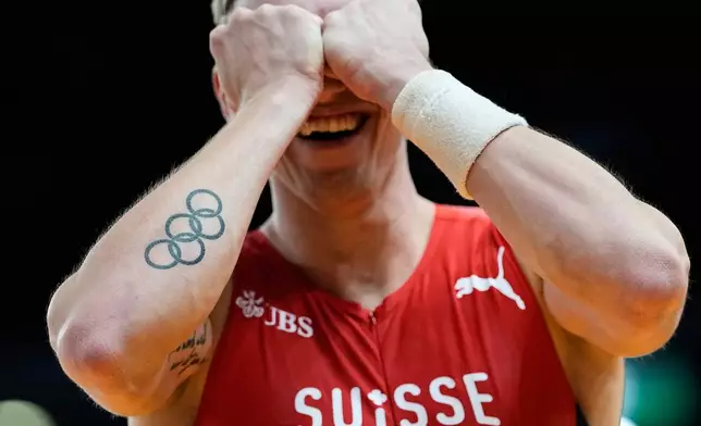 Simon Ehammer, of Switzerland, reacts after a successful attempt in the heptathlon pole vault at the World Athletics Indoor Championships in Torun, Poland, Saturday, March 21, 2026. (AP Photo/Matthias Schrader)