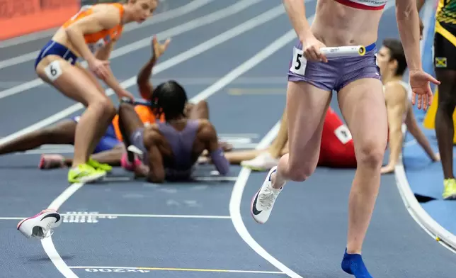 Sara Reifenrath, of the United States, continues the mixed 4 X 400 meters relay, after loosing her shoe at the World Athletics Indoor Championships in Torun, Poland, Saturday, March 21, 2026. (AP Photo/Petr David Josek)