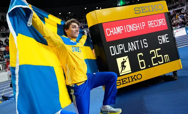 Armand Duplantis, of Sweden, poses after winning the gold medal and setting a new championship record in the men's pole vault final at the World Athletics Indoor Championships in Torun, Poland, Saturday, March 21, 2026. (AP Photo/Matthias Schrader)