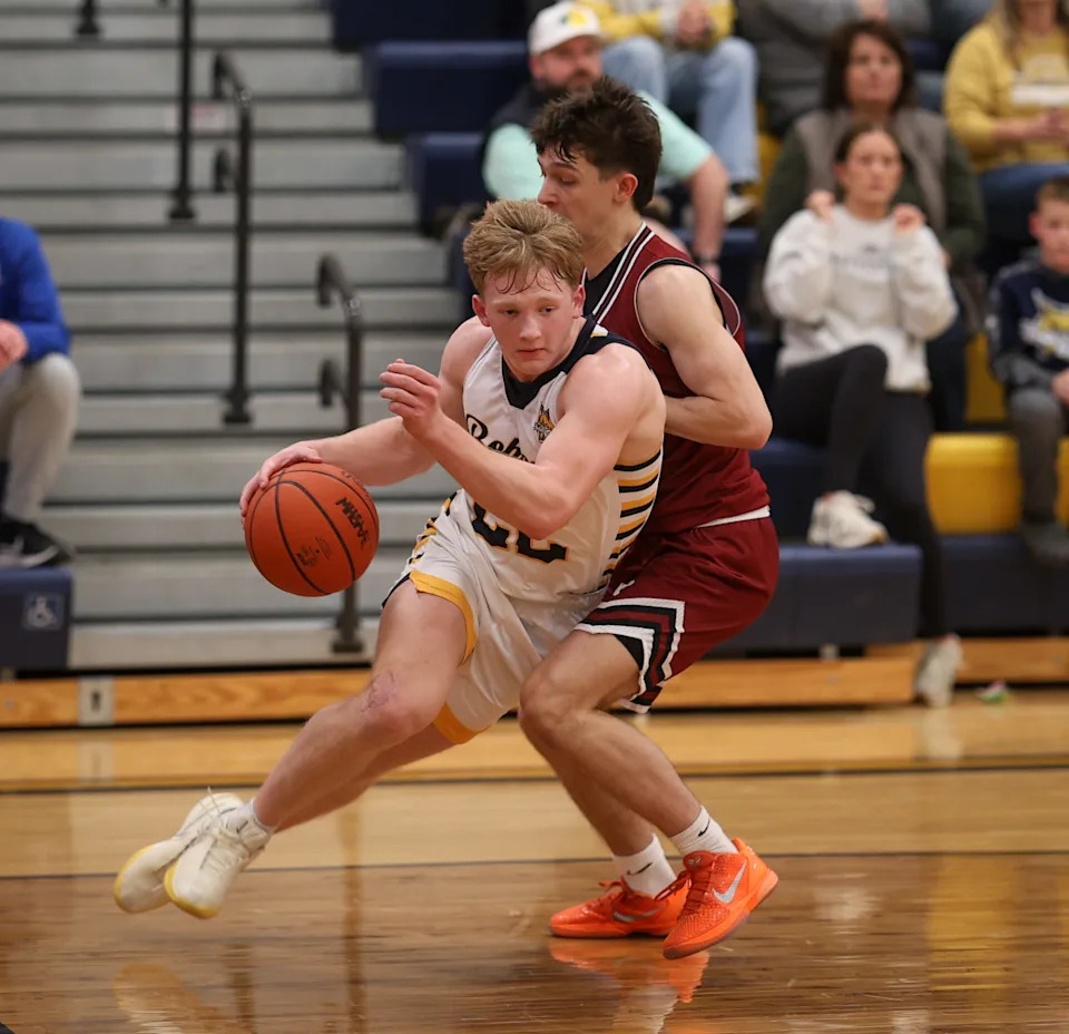 Whiteford's Brek Ruddy works around George Assimacopoulos during a 55-39 victory over Riverview Gabriel Richard in the finals of the Division 3 Boys Basketball District at Erie Mason on Friday, Feb. 27, 2026.