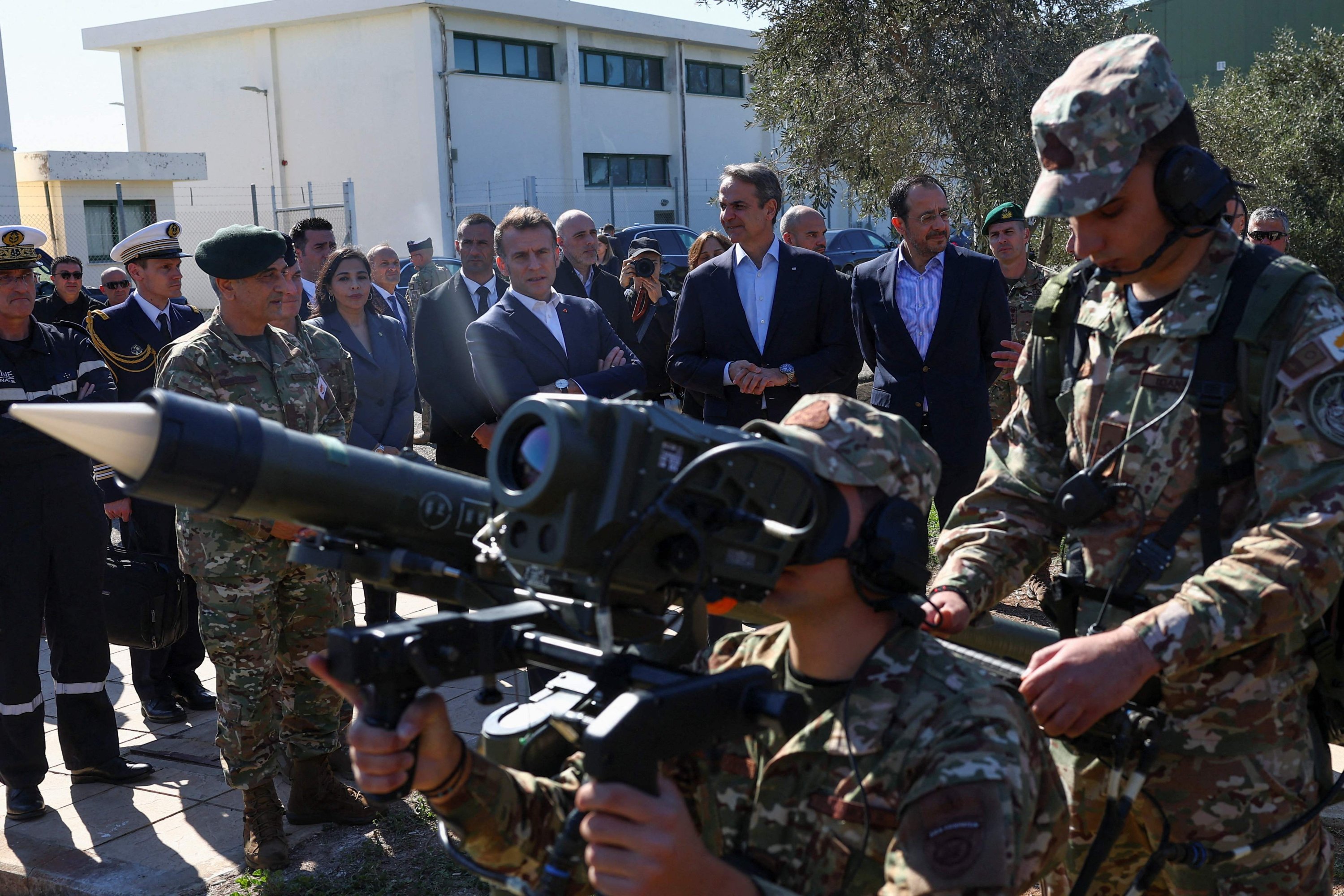 French President Emmanuel Macron (L), Greek Cypriot leader Nikos Christodoulides (R) and Greek Prime Minister Kyriakos Mitsotakis (C) watch military personnel from the Greek Cypriot air force demonstrate a weapon system at Paphos Military Base, Greek Cypriot administration, March 9, 2026. (AFP Photo)