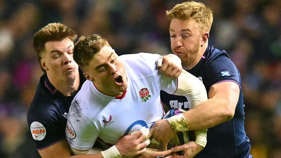 Scottish defenders Huw Jones and Kyle Steyn tackle England winger Tommy Freeman during the Six Nations game at Murrayfield on 14 February 2026