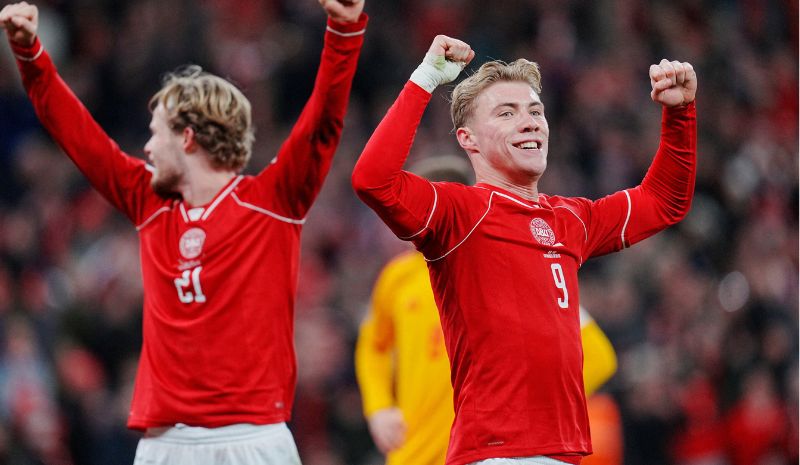 Denmark's Morten Hjulmand and Rasmus Hojlund celebrate a goal.