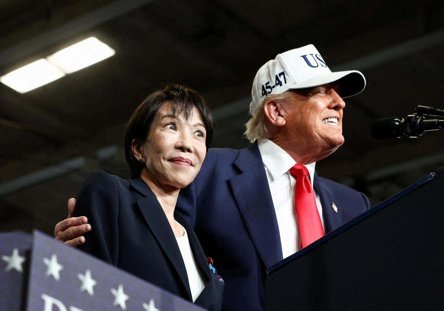 Japanese Prime Minister Sanae Takaichi reacts as U.S. President Donald Trump speaks, aboard the aircraft carrier USS George Washington, during a visit to U.S. Navy's Yokosuka base in Yokosuka, Japan, on Oct. 28, 2025. [REUTERS/YONHAP]