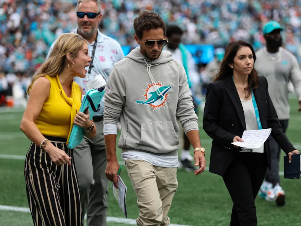 Oct 5, 2025; Charlotte, North Carolina, USA; Miami Dolphins head coach Mike McDaniel talks with a reporter at the end of the first half of the Carolina Panthers and Miami Dolphins game at Bank of America Stadium. Mandatory Credit: Cory Knowlton-Imagn Images