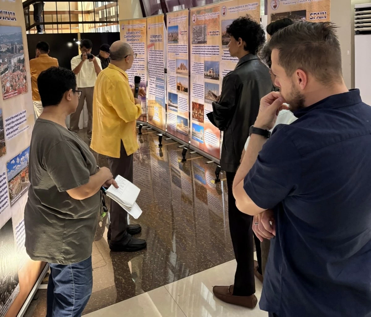Attendees wander through the exhibit, drawn into fascinating reads and eye‑opening perspectives
