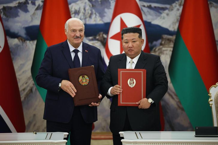 Belarusian President Alexander Lukashenko and North Korean leader Kim Jong-un hold signed documents during a meeting in Pyongyang, North Korea, March 26, in this photo from the Belarusian presidential press service. EPA-Yonhap