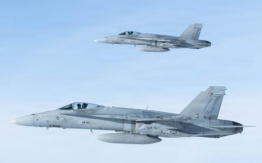 Two fighter jets in flight.