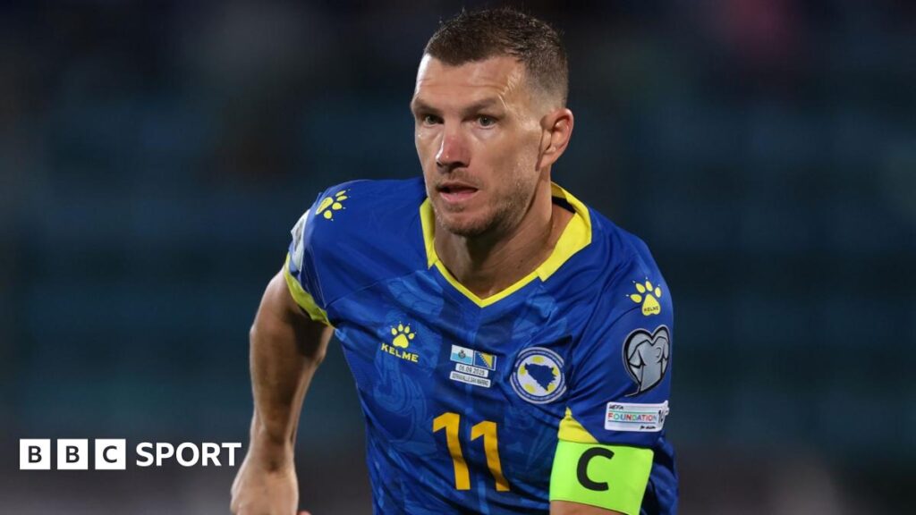 Edin Dzeko wearing the captain's armband in the blue kit of Bosnia-Herzegovina