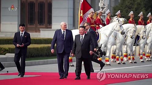 North Korean leader Kim Jong-un (R) welcomes Belarusian President Alexander Lukashenko's visit to North Korea in a ceremony in Pyongyang on March 25, 2026, in this image captured the next day from the Korean Central Television. (For Use Only in the Republic of Korea. No Redistribution) (Yonhap)