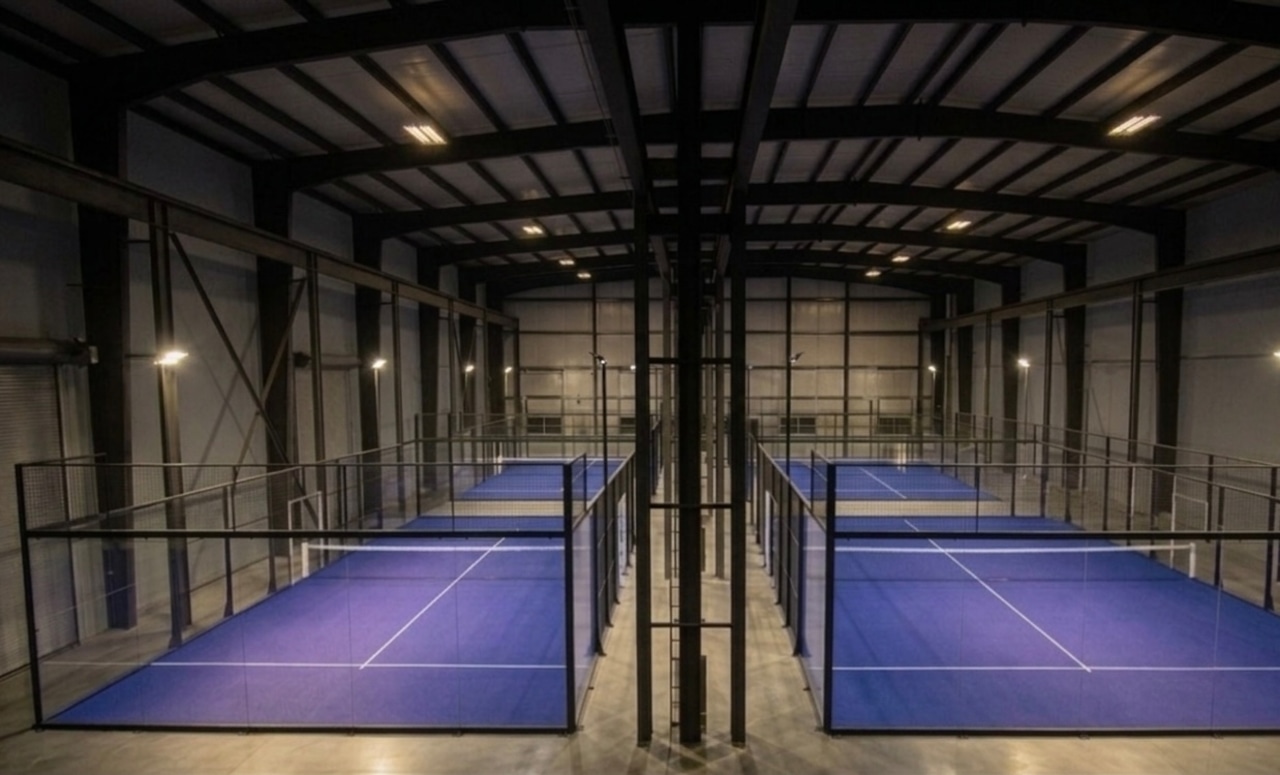 Rendering of room with four blue indoor padel courts