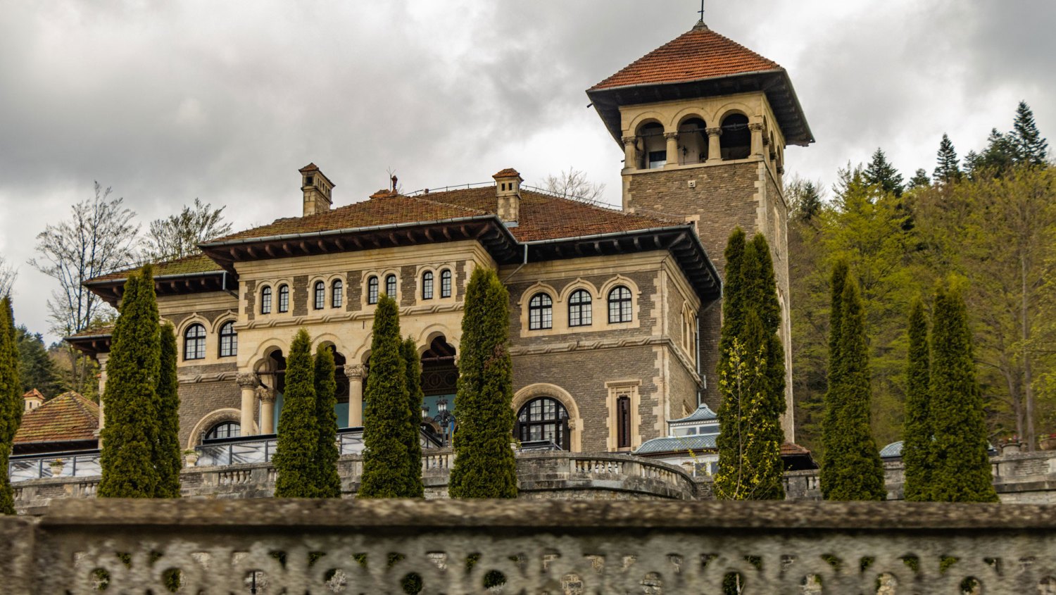 Filming Location for Wednesday-Romania. Cantacuzino castle located in Busteni town in Bucegi Mountains. Palace close up view with courtyard in Prahova Valley by mountains.