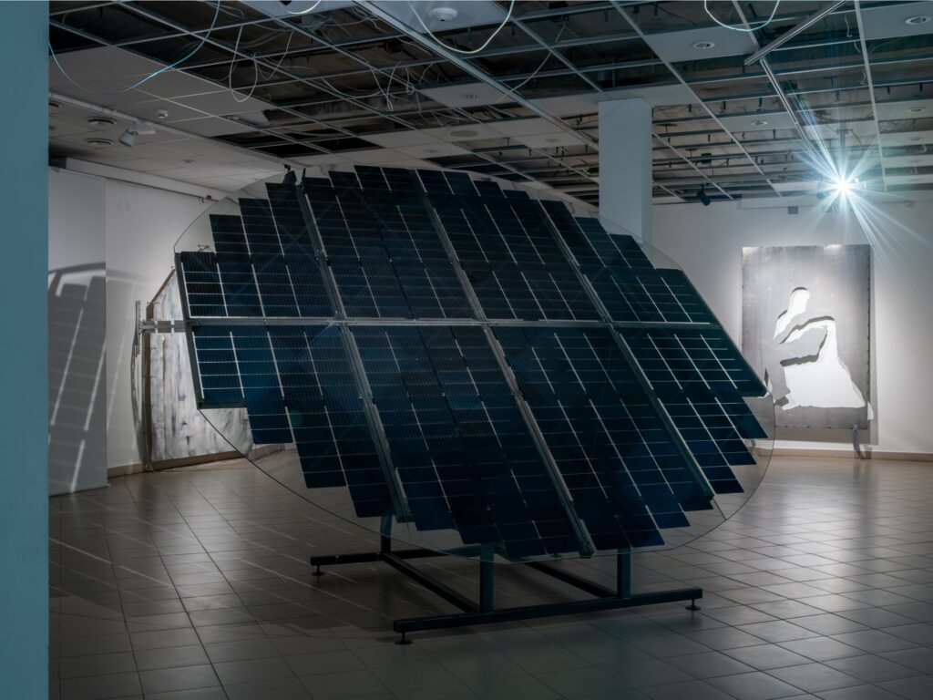 Agata Orlovska, “Do Not Go Gentle Into That Good Night”, 2024, solar panels, tempered glass, steel. Exhibition view_ “Dymaxion”, KKKC, Klaipėda, Lithuania. Photo by Laurynas Skiesgaila. Courtesy of the artist