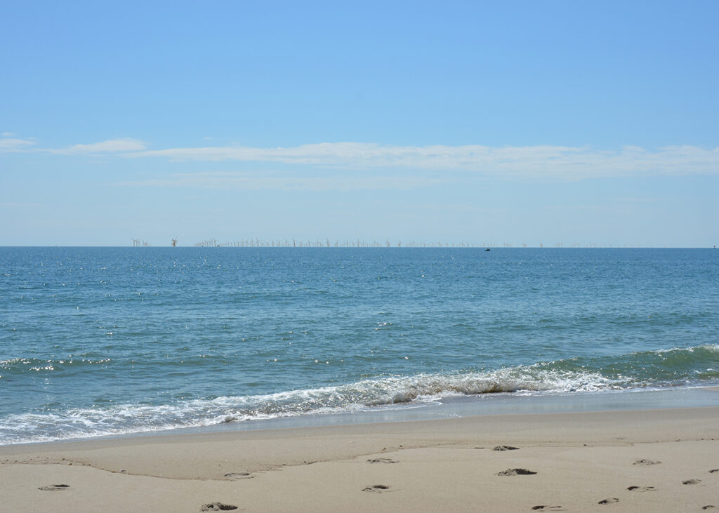 This image from a visualization study commissioned by the Southeast Wind Coalition in 2022 for the Carolina Long Bay offshore wind project that is now scuttled shows how the turbines would appear from the beach at Bald Head Island.