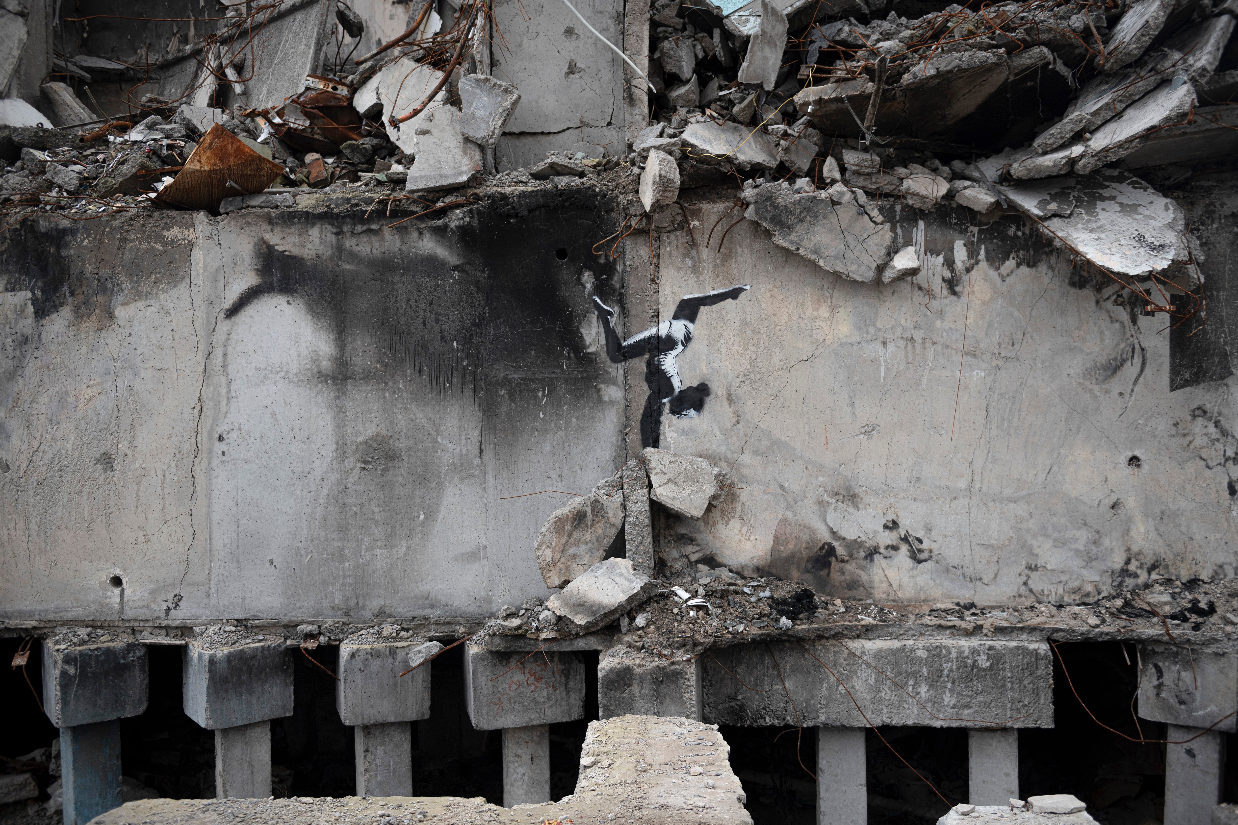 File. A painting by British street artist Banksy is seen on a building destroyed by fighting in Borodyanka, Kyiv region, Ukraine, Sunday, 13 Nov 2022