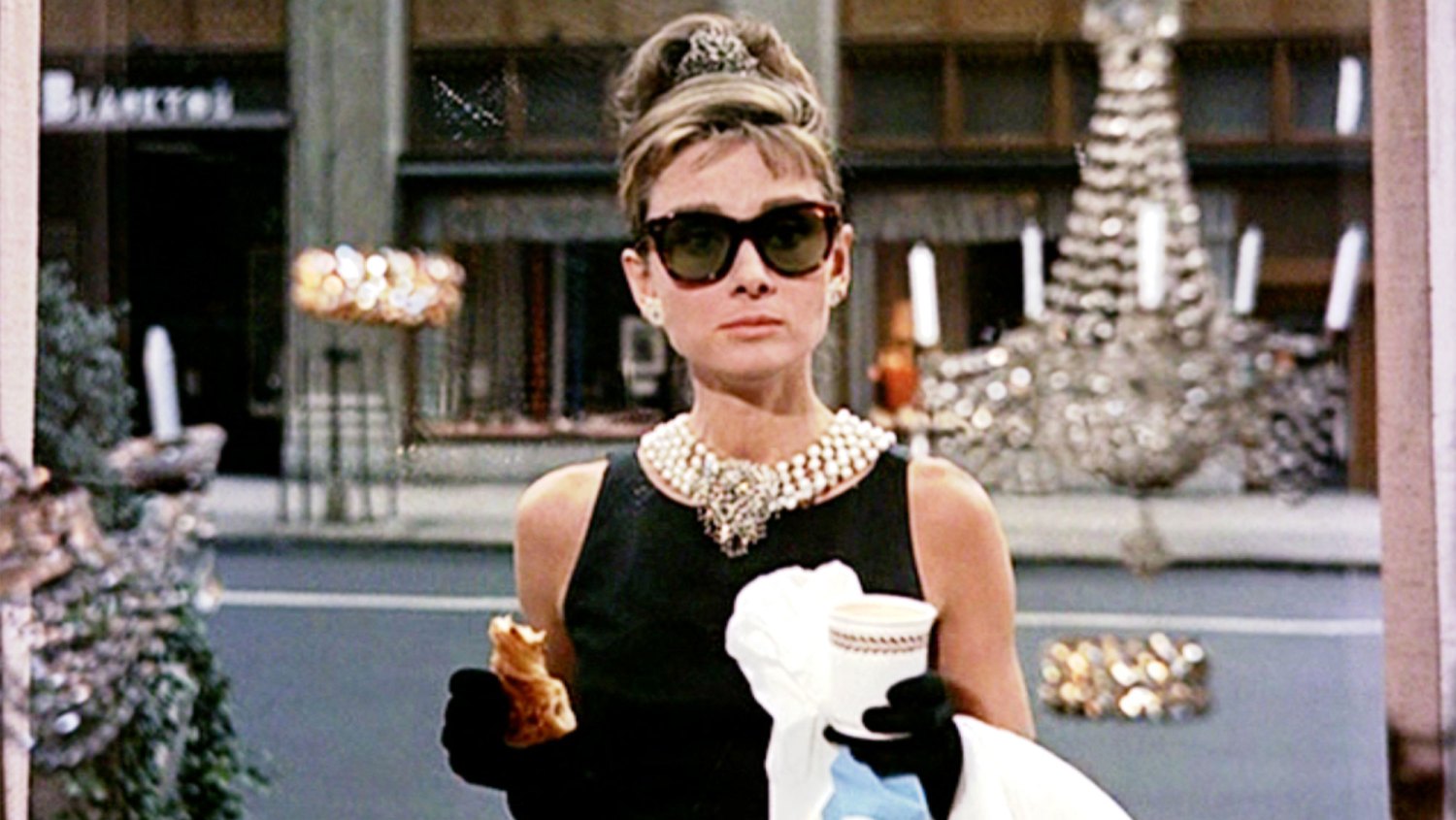 Breakfast at Tiffany's NEW YORK - OCTOBER 5: The movie Breakfast at Tiffany's, directed by Blake Edwards and based on the novel by Truman Capote. Seen here, Audrey Hepburn as Holly Golightly during the opening sequence, pausing in front of Tiffany's jewelry store in New York City. Initial theatrical release October 5, 1961.