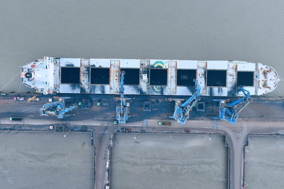Cranes load coal imported from Australia onto trucks on a pier in Rugao city in east China's Jiangsu province. (Photo credit should read WU SHUJIAN / Feature China/Future Publishing via Getty Images)