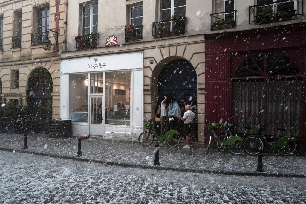 A Warmer Climate Means Bigger Hail People take cover as a thunderstorm, accompanied by heavy hail, sweeps through Paris on May 3, 2025. Credit: Jerome Gilles/NurPhoto via Getty Images