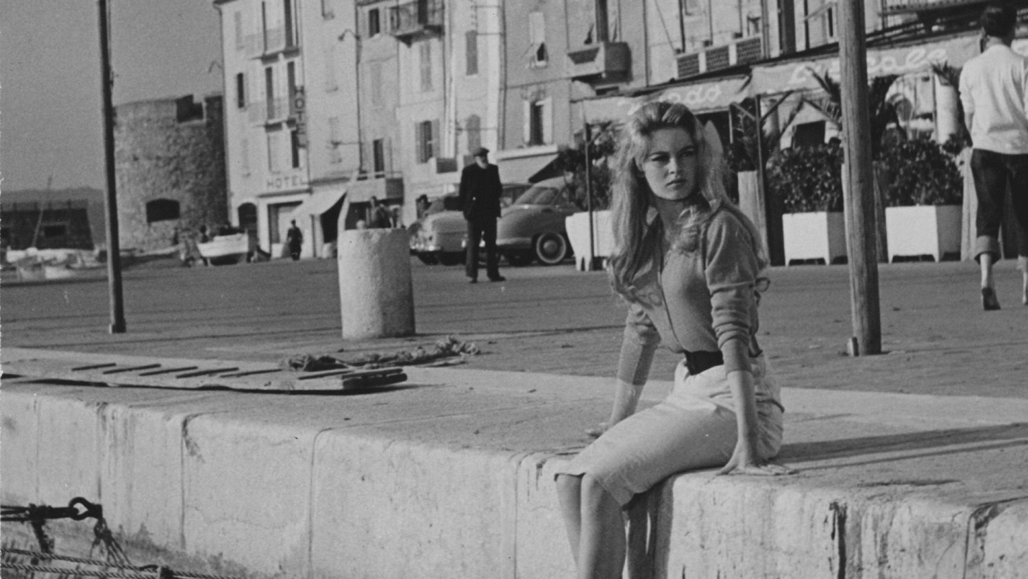 Brigitte Bardot In ...And God Created Woman Brigitte Bardot sitting on a quay by the ocean in Saint-Tropez in the 1956 film directed by Roger Vadim, And God Created Woman.
