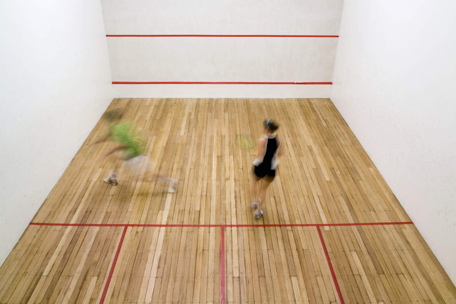High-angle view of two people playing squash. (Getty Images)