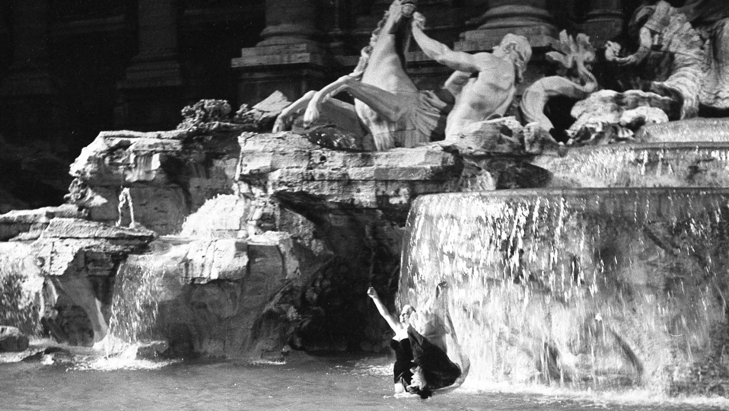 The famous film set of La Dolce Vita at Trevi Fountain while the actress Anita Ekberg take a bath in the Trevi fountain, Rome 1959.
