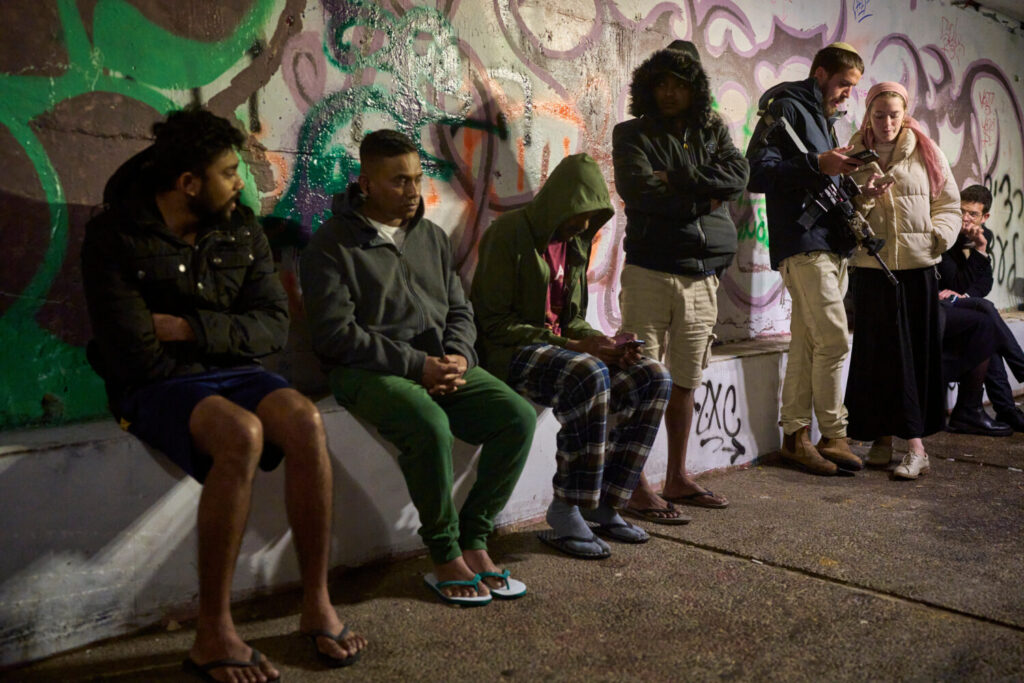 People take shelter in an Underground tunnel as air raid sirens signal a warning of incoming Irania...
