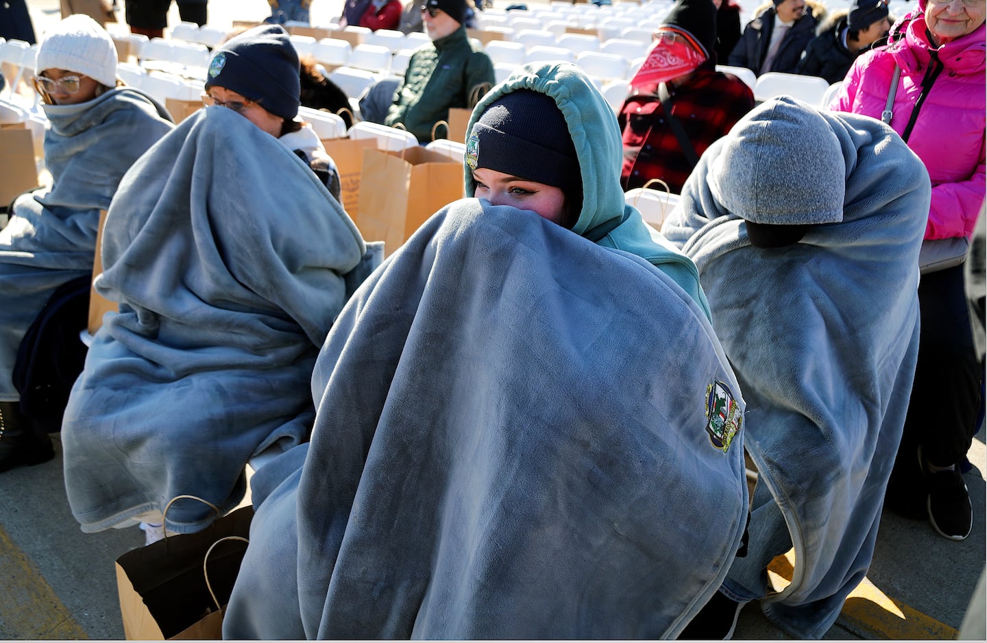 Autumn Frazier from Hampden, Va. and others bundled up in the cold, as they waited for the start of a ceremony.