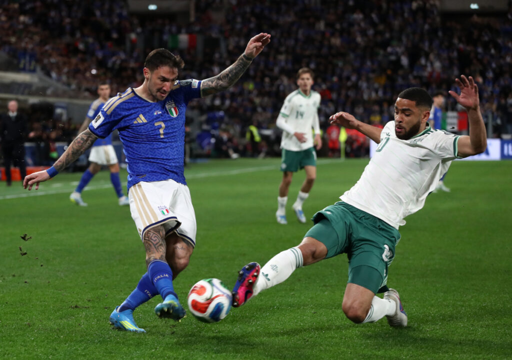 BERGAMO, ITALY - MARCH 26: Matteo Politano of Italy is challenged by Brodie Spencer of Northern Ireland during the FIFA World Cup 2026 European Qualifiers KO play-offs match between Italy and Northern Ireland at Stadio di Bergamo on March 26, 2026 in Bergamo, Italy. (Photo by Marco Luzzani/Getty Images)