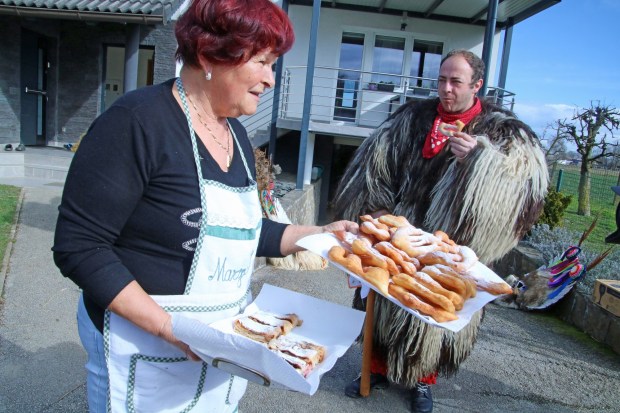 A women brings out home-baked pastries for Kurents at her house in Spuhlja. (Photo by Norma Meyer)