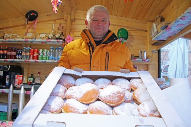 A vendor in Ptuj sells krofi, the Slovenian jam-filled doughnuts gobbled up by the thousands during carnival time. (Photo by Norma Meyer)