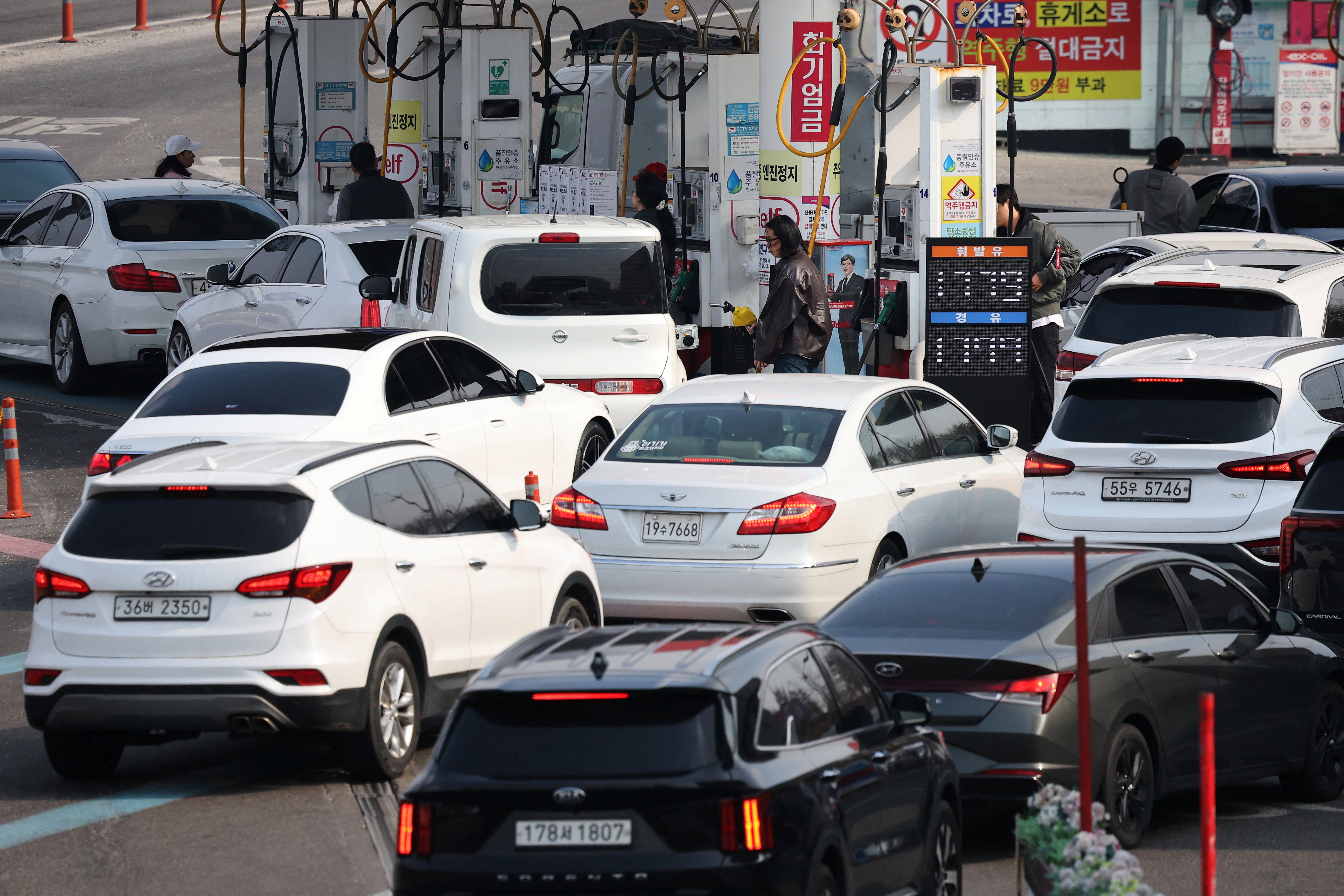 Cars line up at a gas station in Seoul