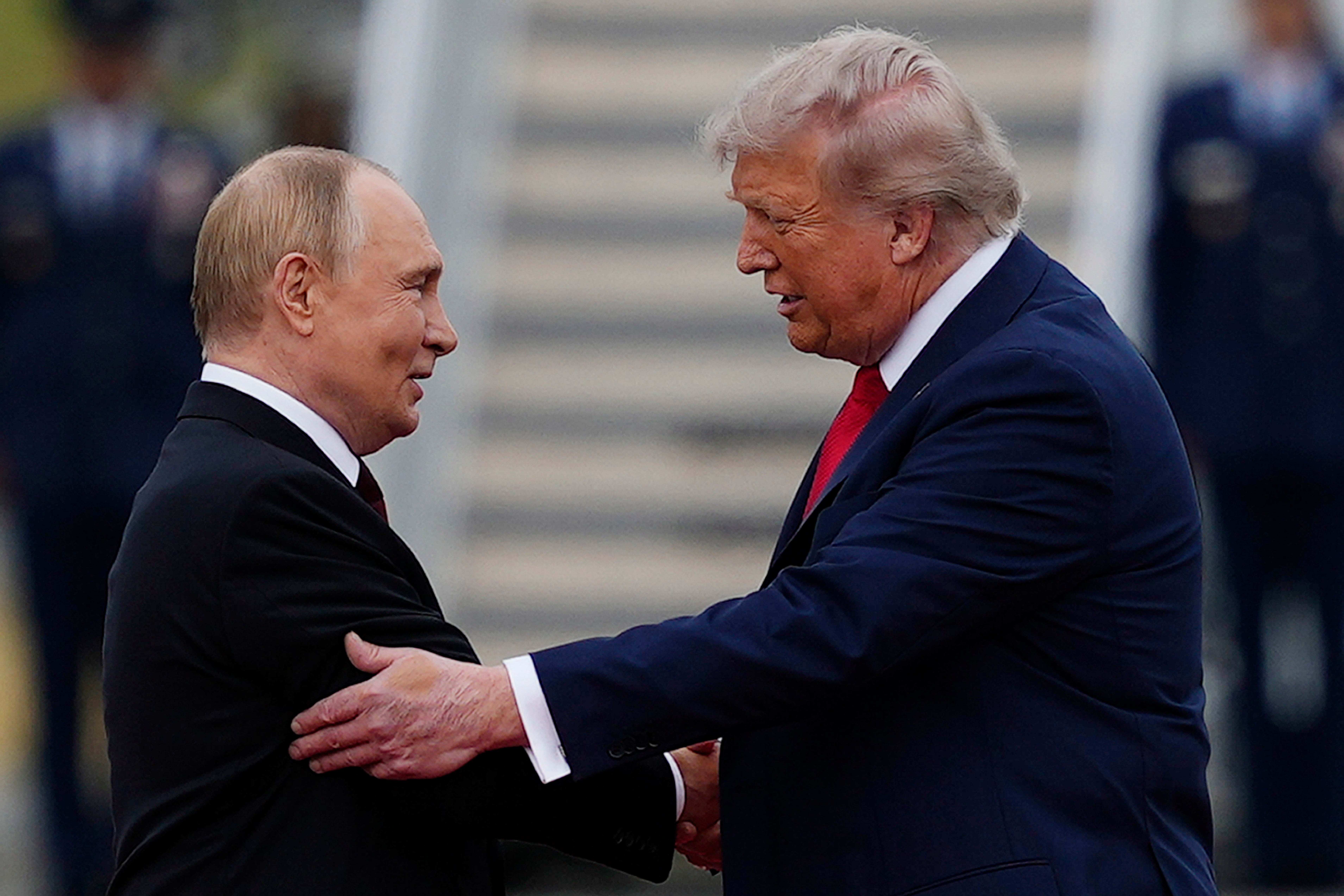 US president Donald Trump greets Russian president Vladimir Putin at Joint Base Elmendorf-Richardson, Alaska