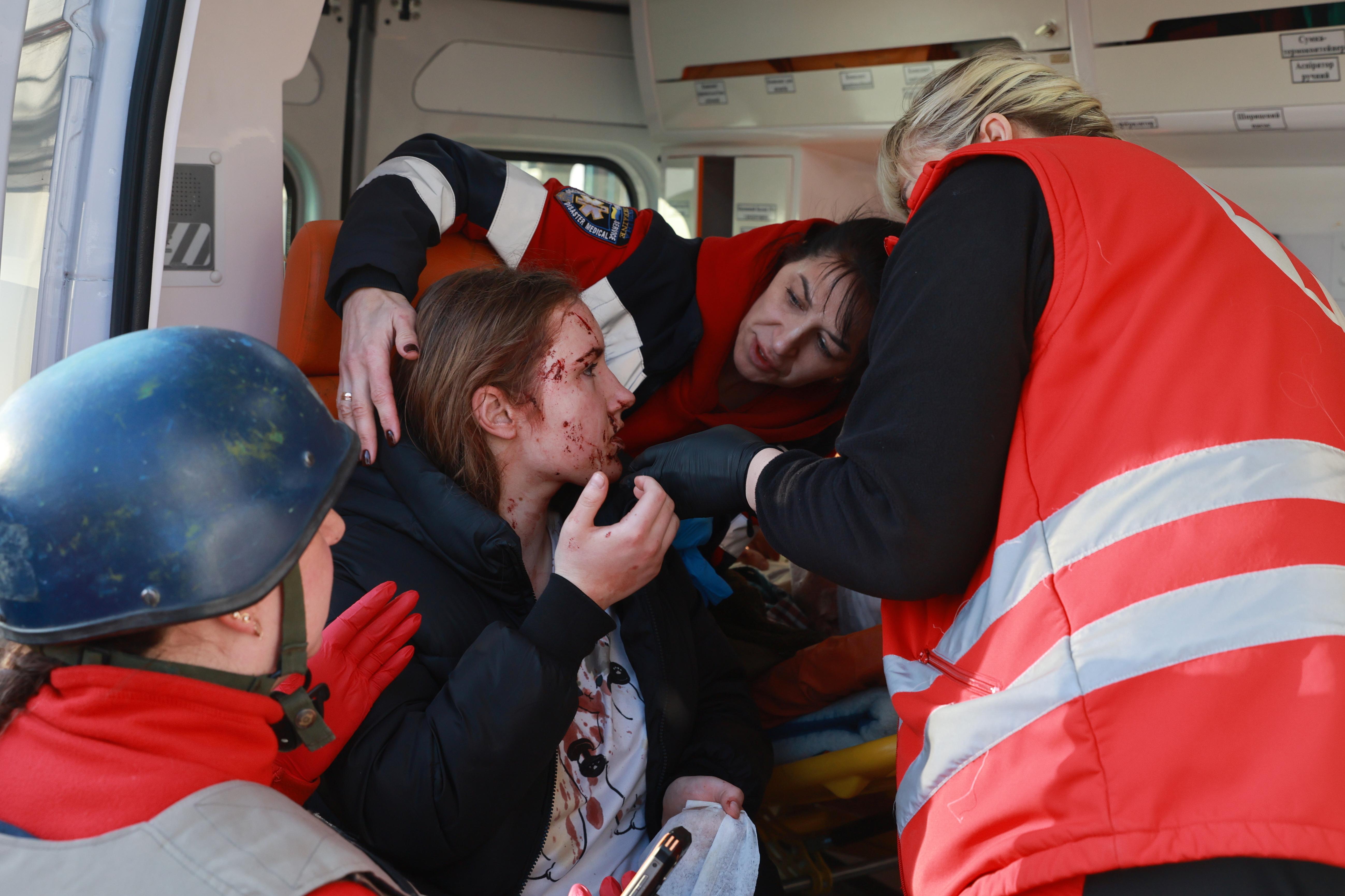 Paramedics give first aid to an injured resident following Russian...