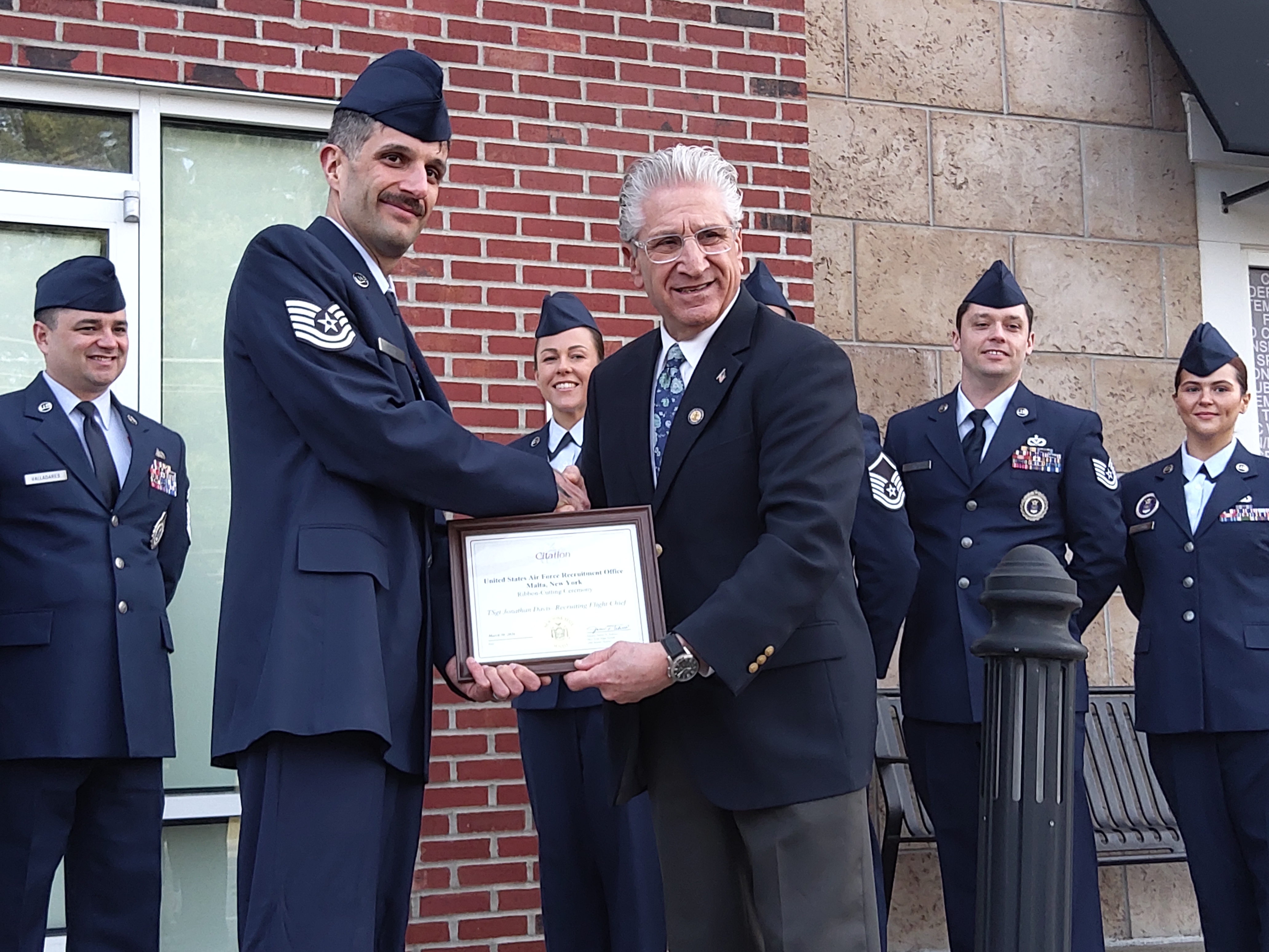 Technical Sergeant Jonathan Davis receives a commendation from Senator Jim Tedisco for the US Air Force's new Malta office. (Melissa Schuman - MediaNews Group)